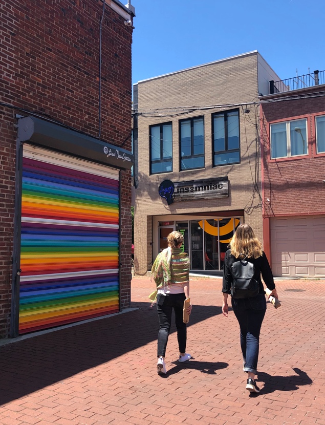 Two women walking through Blagden Alley 